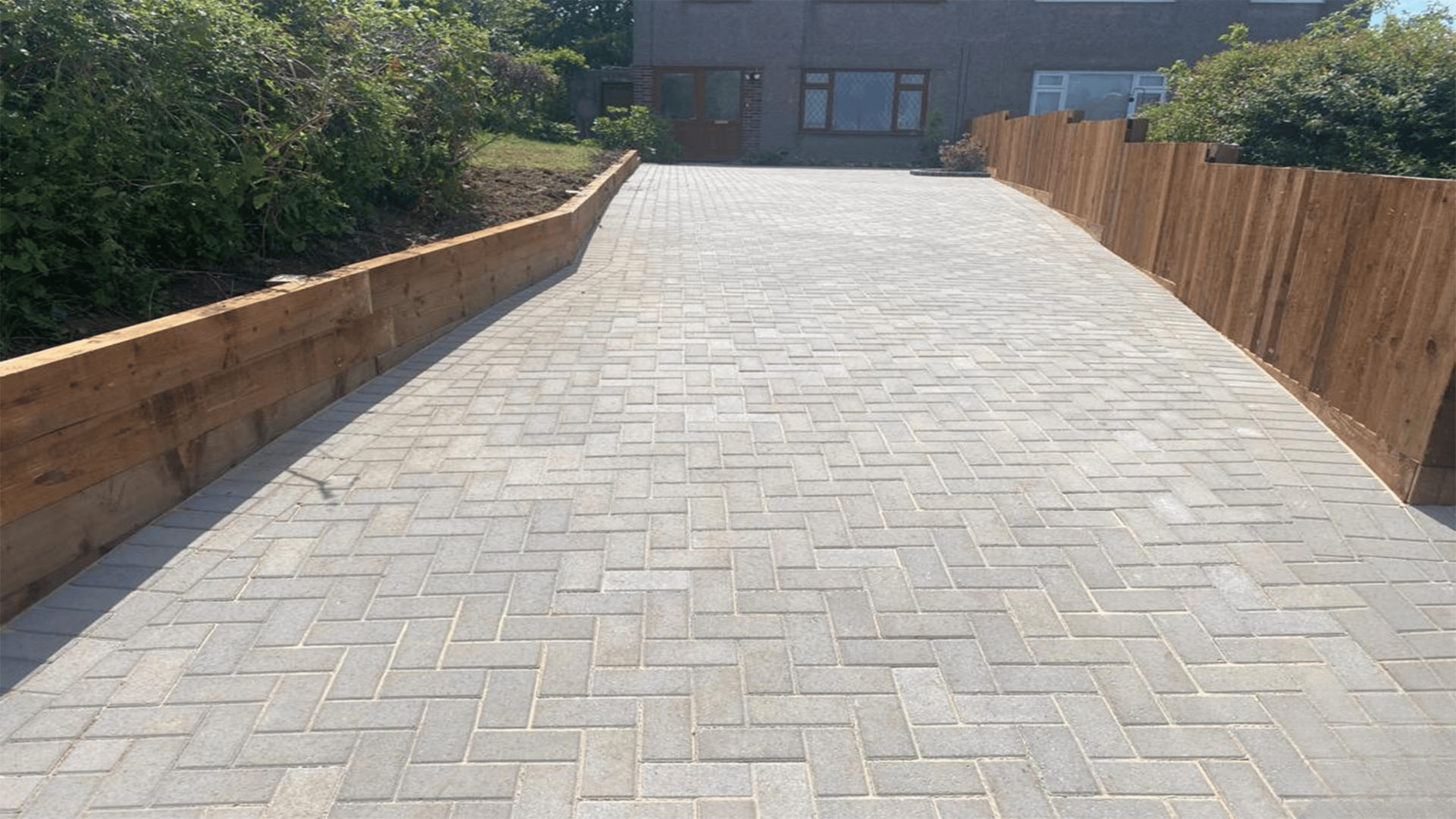 Modern front garden featuring clean lines, gravel borders, low-maintenance planting, and a stylish pathway leading to the entrance